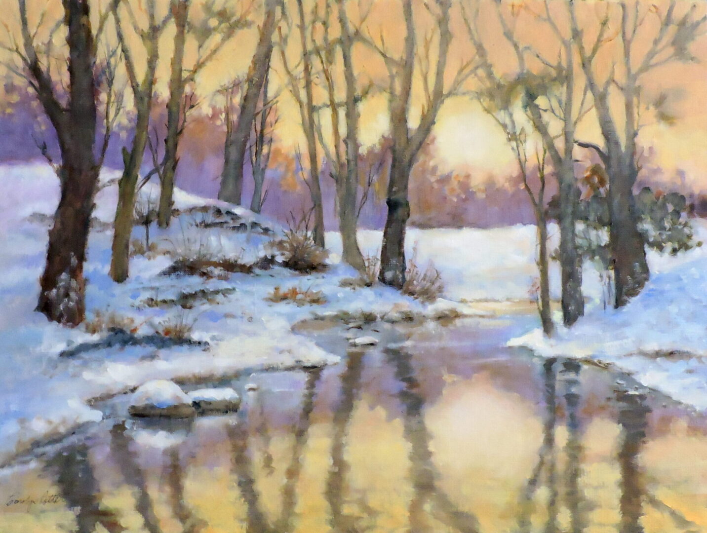 A serene winter sunset over a snow-covered creek reflecting colorful skies.